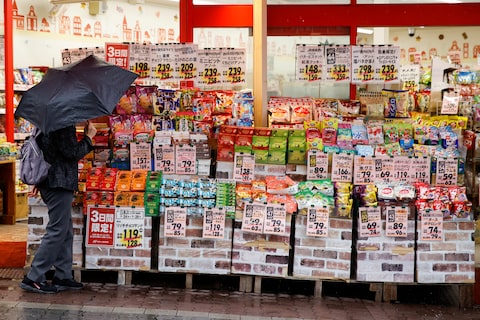 A woman looks at items at a shop in Tokyo